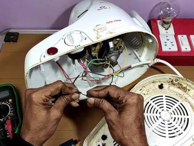 Mixer grinder motor repair with multimeter testing on workbench